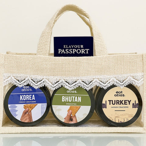 International Flavors in a cute Jute basket- Bhutan and Korea Dip (200 gms each) with Lavash Chips (85 gms)